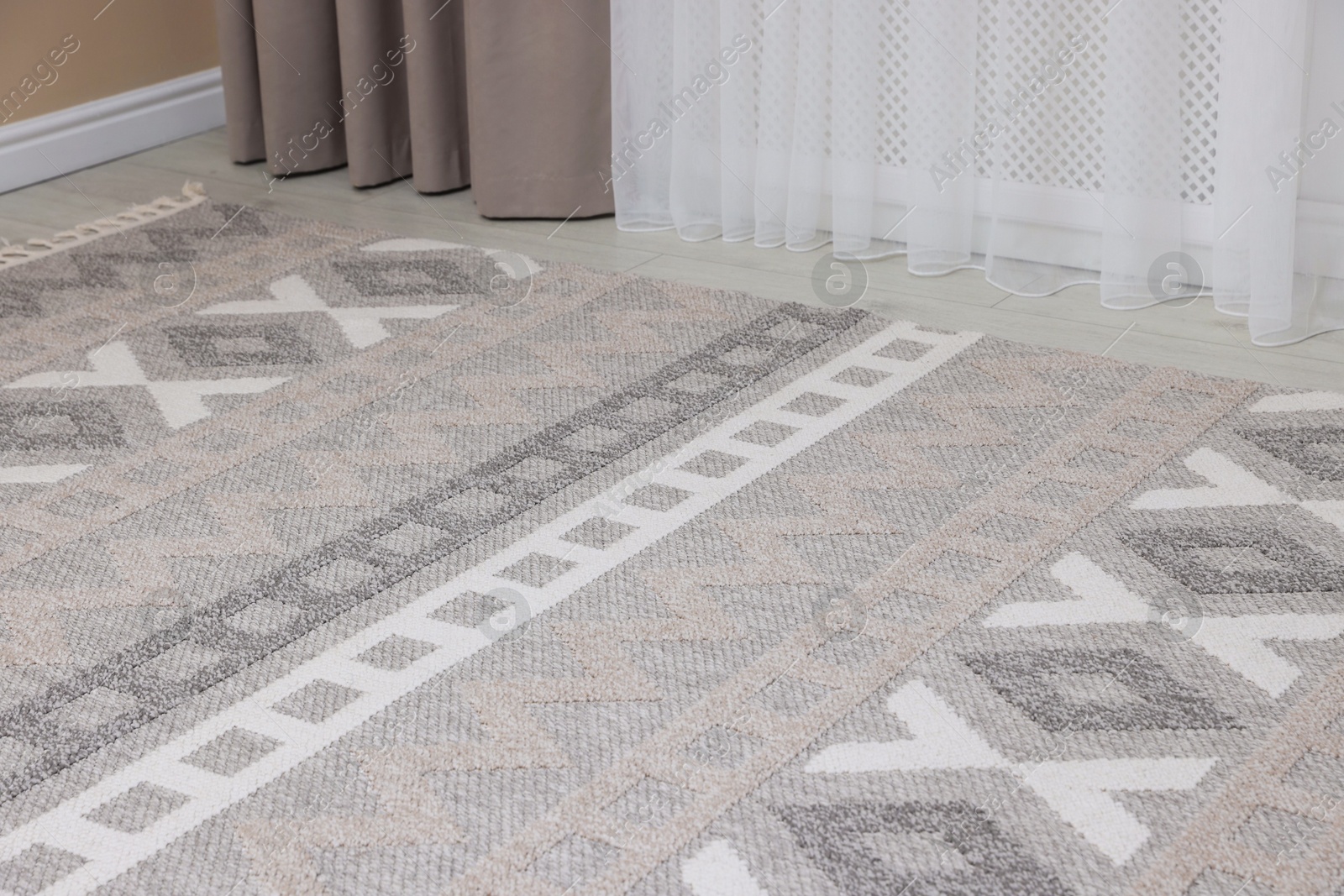 Stylish soft rug with pattern on floor indoors Photo of Stylish soft rug with pattern on floor indoors