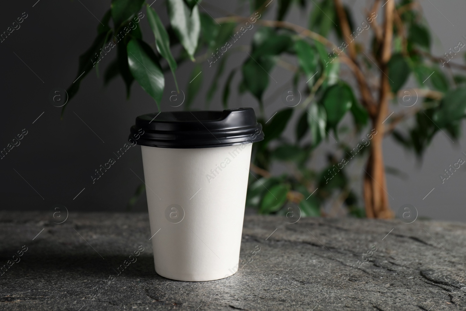 Paper cup on grey textured table indoors, closeup. Mockup for design Photo of Paper cup on grey textured table indoors, closeup. Mockup for design