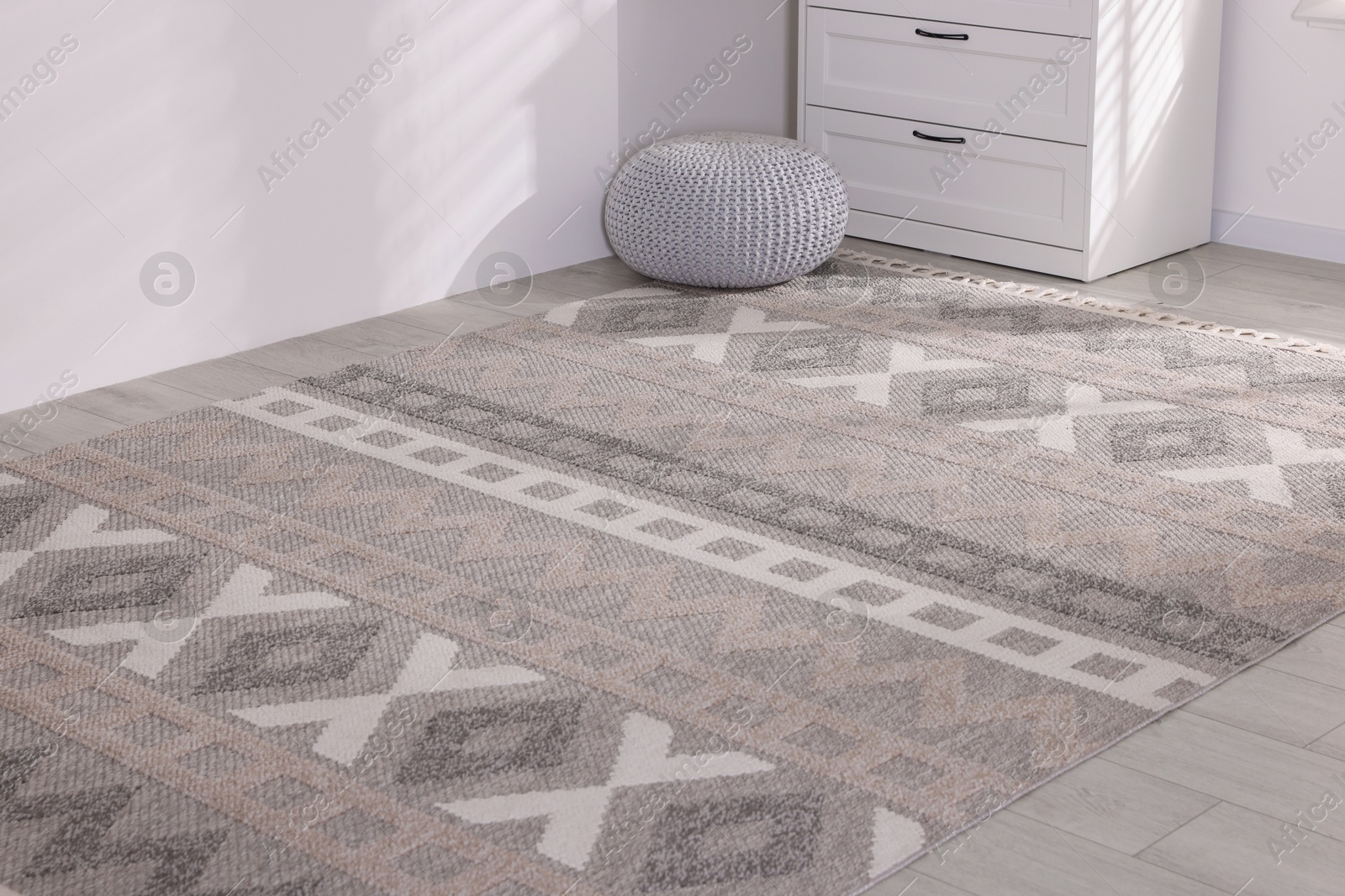 Stylish soft rug with pattern on floor indoors Photo of Stylish soft rug with pattern on floor indoors