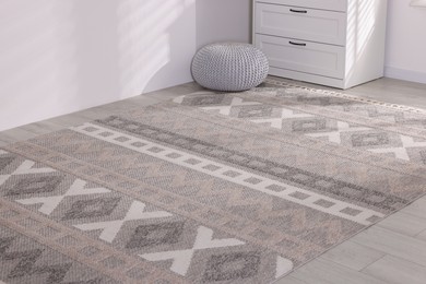 Photo of Stylish soft rug with pattern on floor indoors