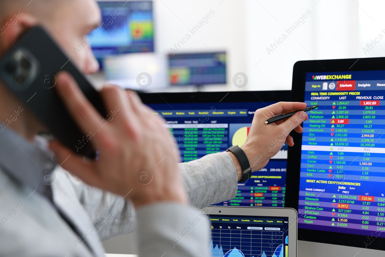 Photo of Financial trading specialist talking on phone in office, selective focus