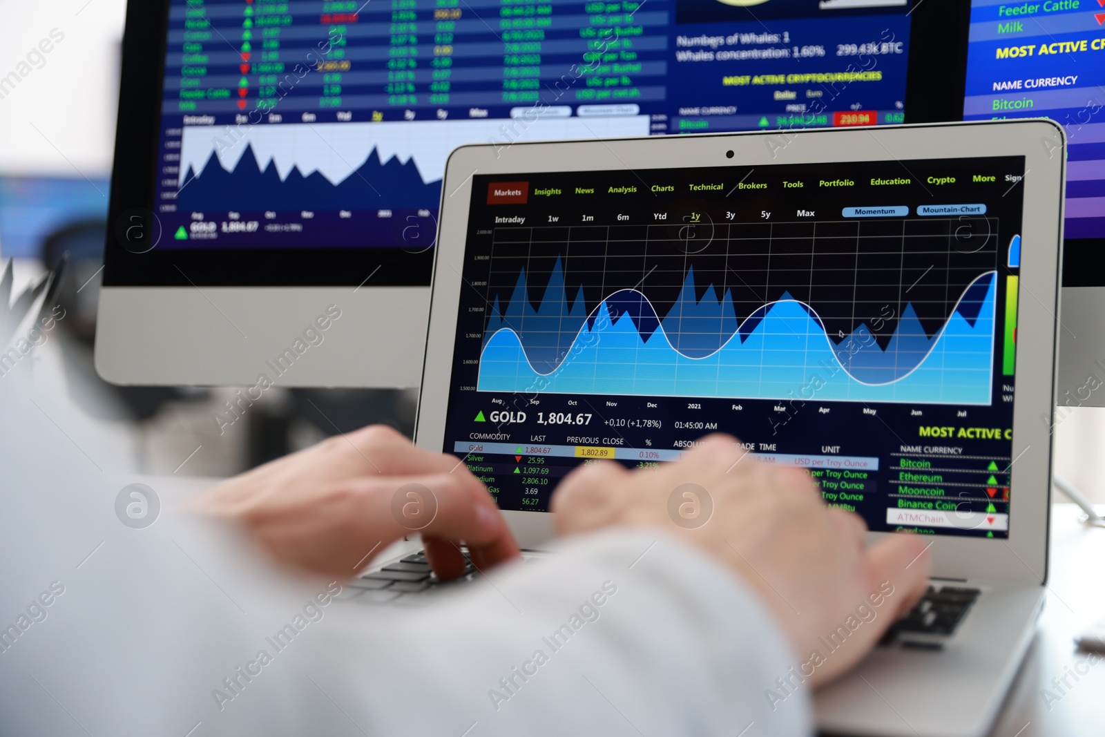 Photo of Financial trading specialist working on laptop at table in office, closeup