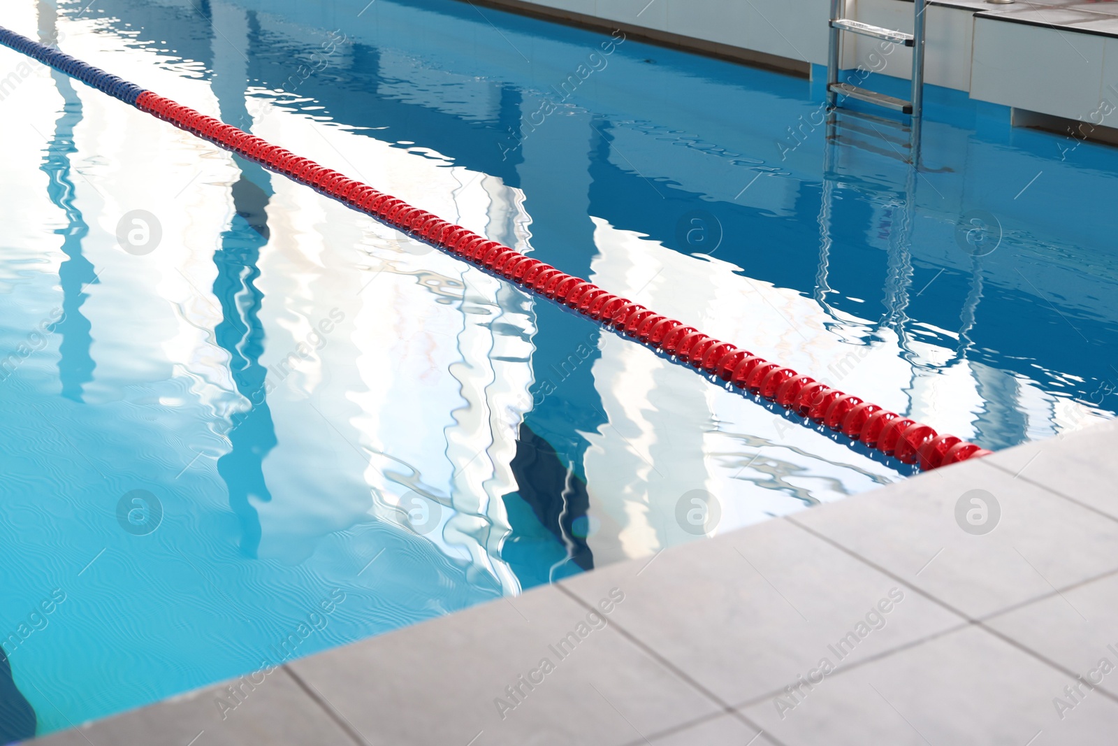 Photo of Swimming pool with clean water and lane dividers indoors