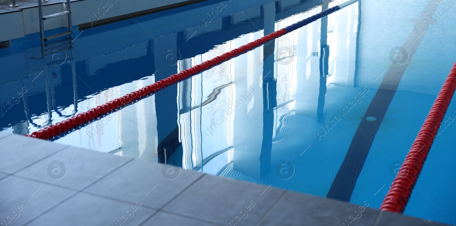 Photo of Swimming pool with clean water and lane dividers indoors