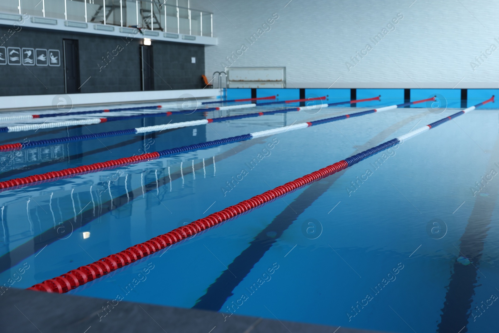 Photo of Swimming pool with clean water and lane dividers indoors