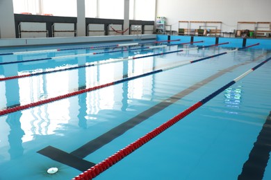 Photo of Swimming pool with clean water and lane dividers indoors