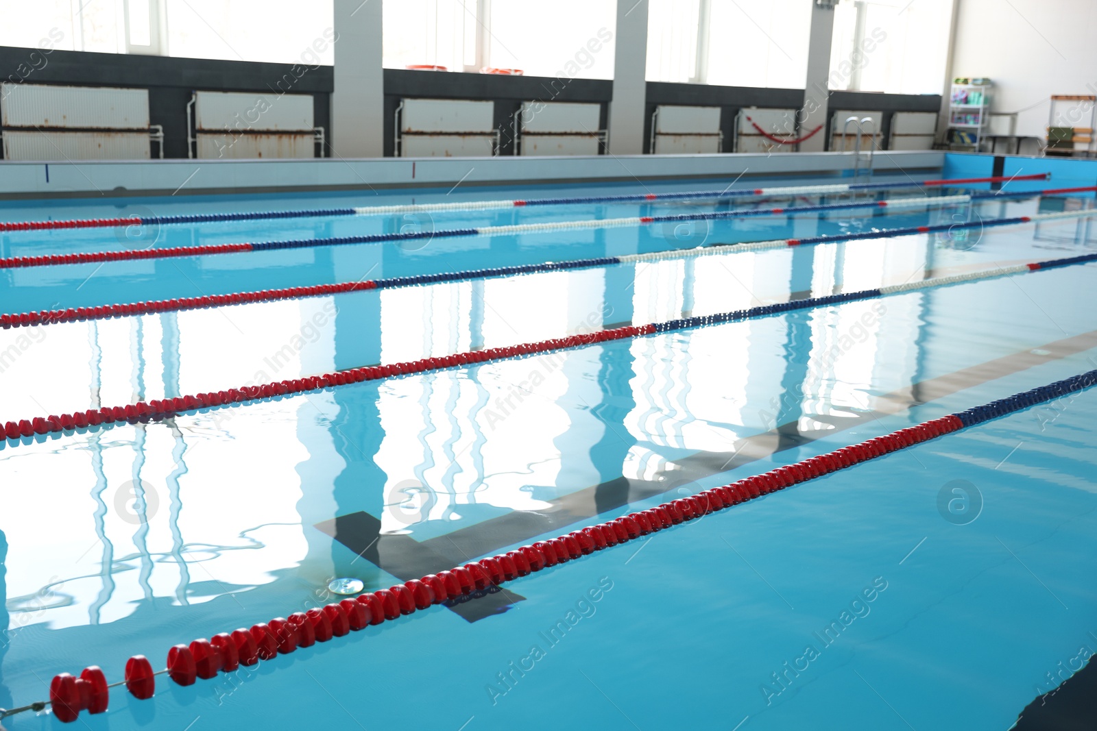 Photo of Swimming pool with clean water and lane dividers indoors