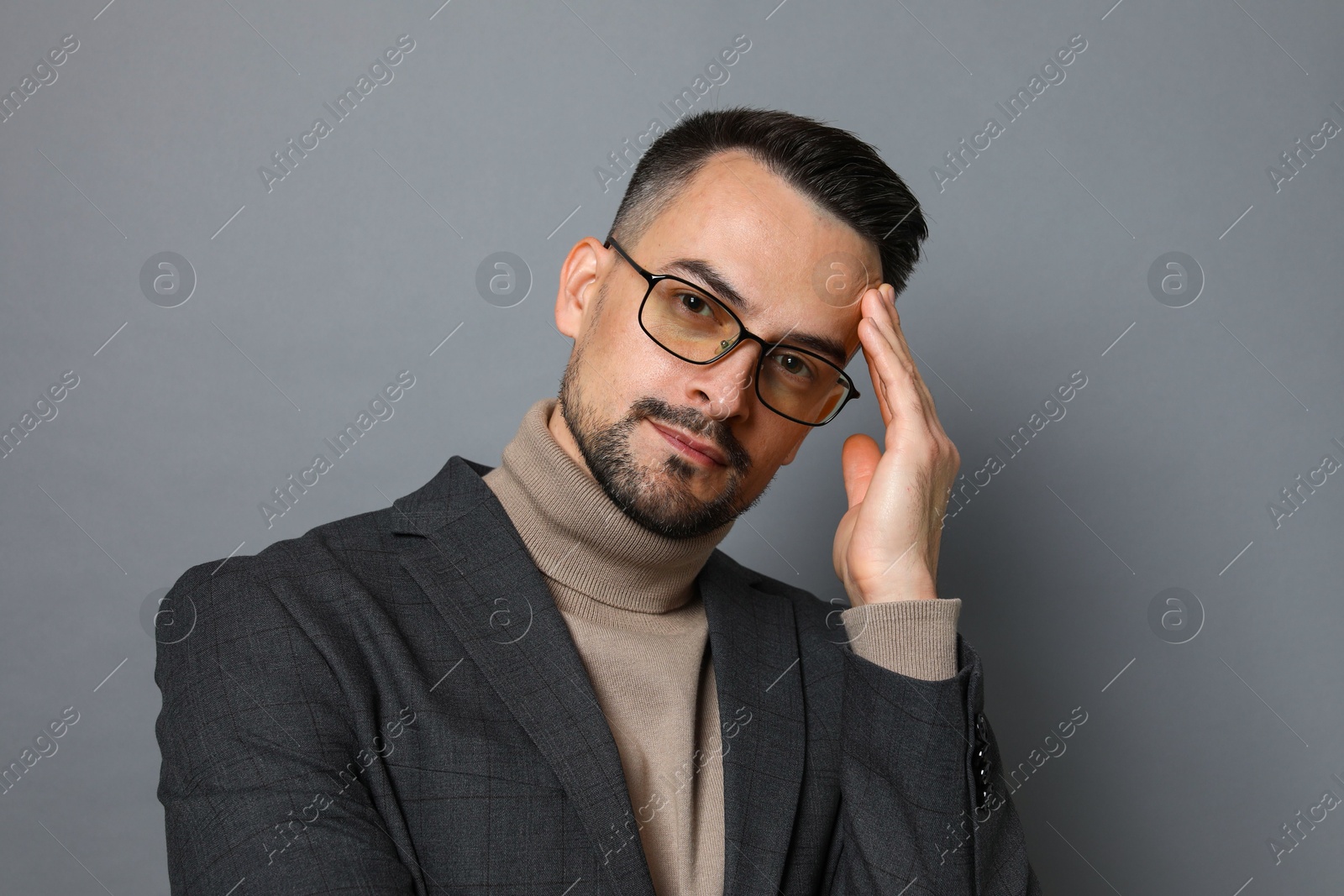 Photo of Portrait of handsome middle aged man on grey background