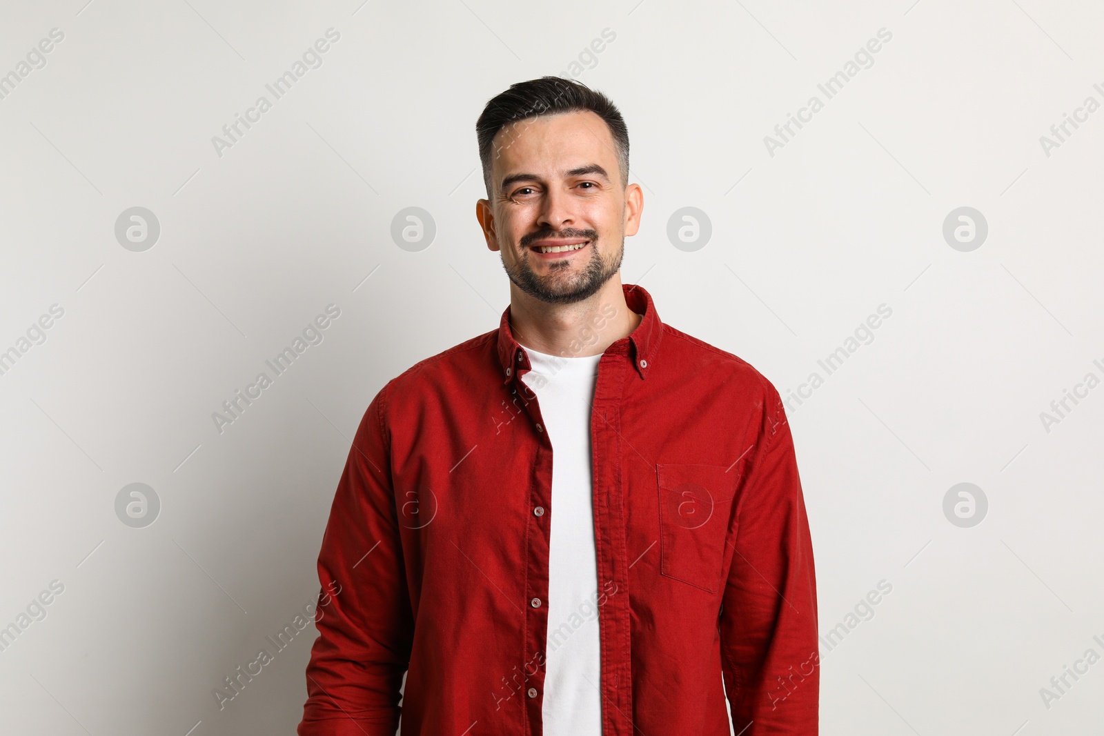 Photo of Portrait of handsome middle aged man on light background