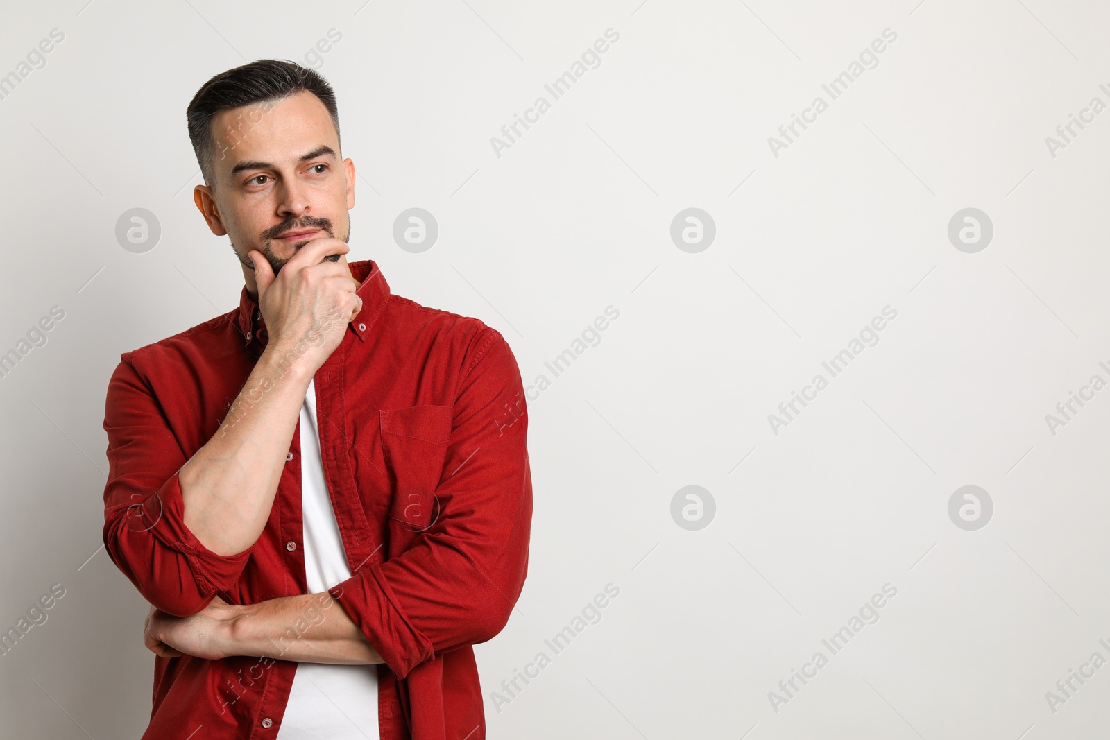 Photo of Portrait of handsome middle aged man on light background, space for text