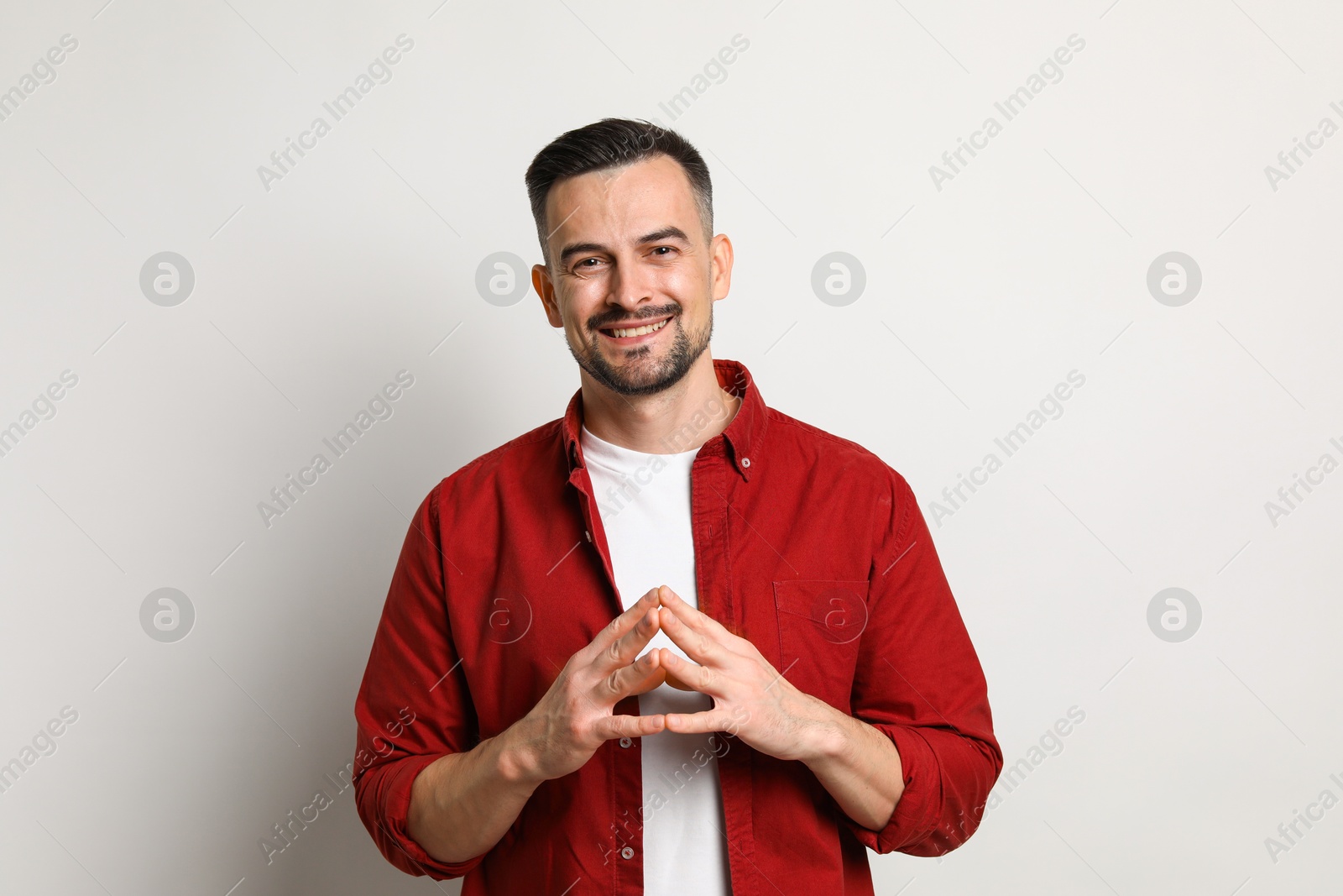 Photo of Portrait of handsome middle aged man on light background