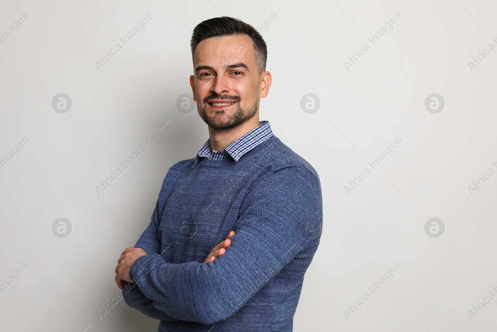 Photo of Portrait of handsome middle aged man on light background