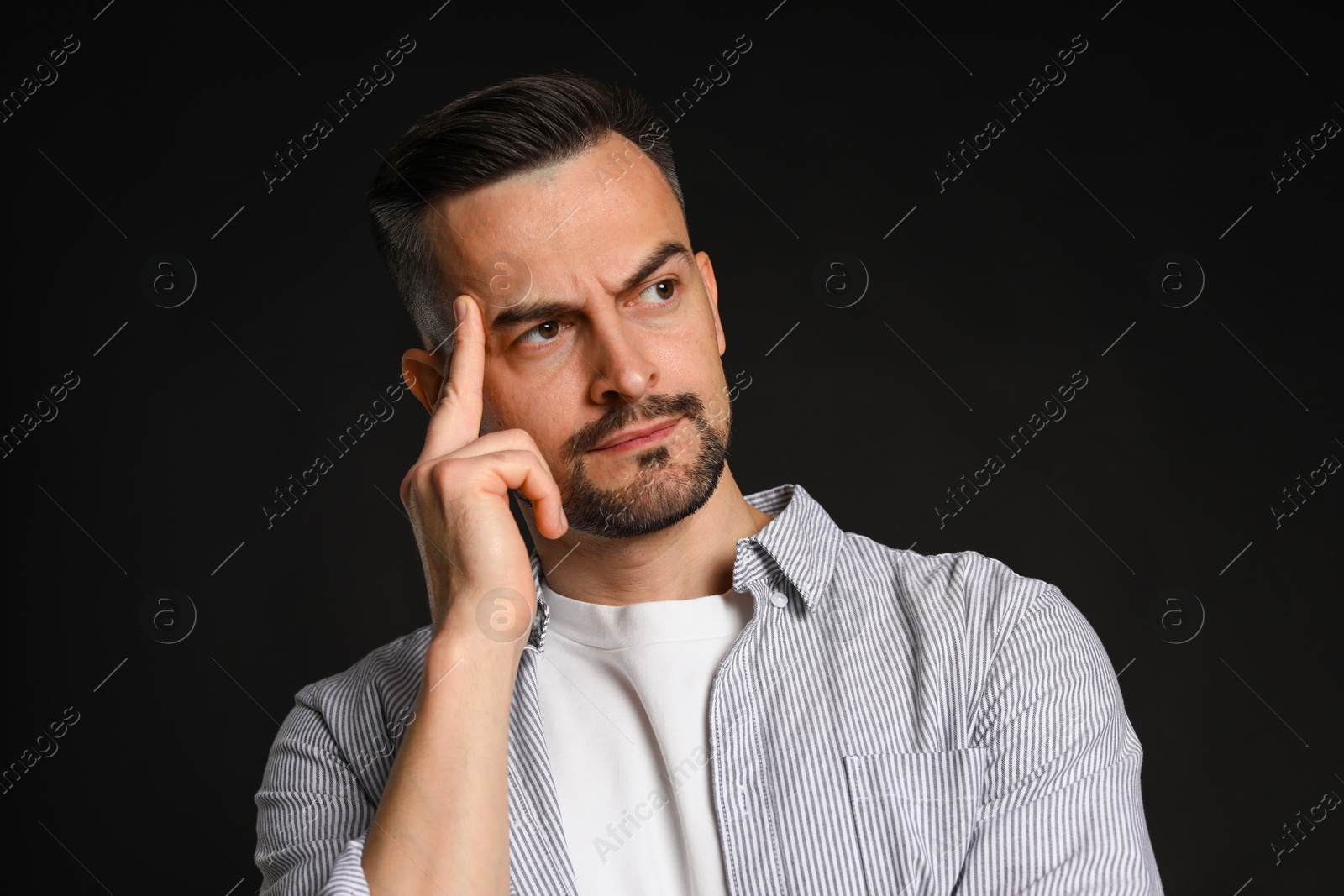 Photo of Portrait of handsome middle aged man on black background