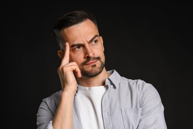 Photo of Portrait of handsome middle aged man on black background