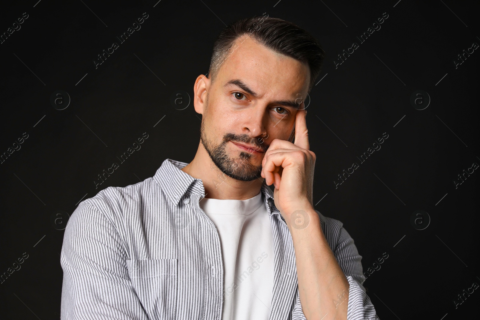 Photo of Portrait of handsome middle aged man on black background