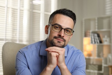 Photo of Portrait of handsome middle aged man indoors