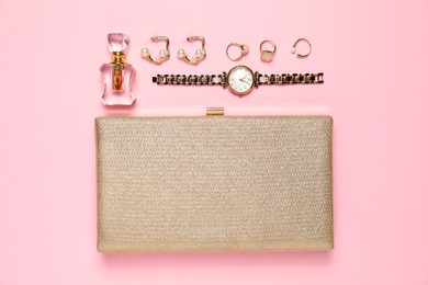 Photo of Many stylish jewelry, perfume and accessories on pink background, flat lay