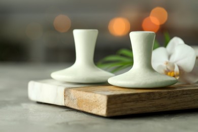 Photo of Spa stones and orchid flower on grey table, closeup