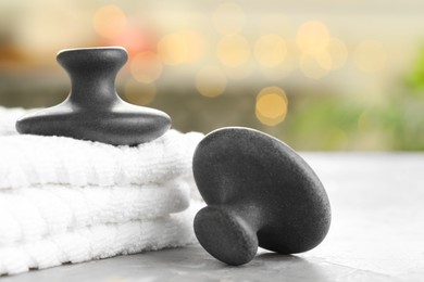 Photo of Spa stones and towels on grey background, closeup