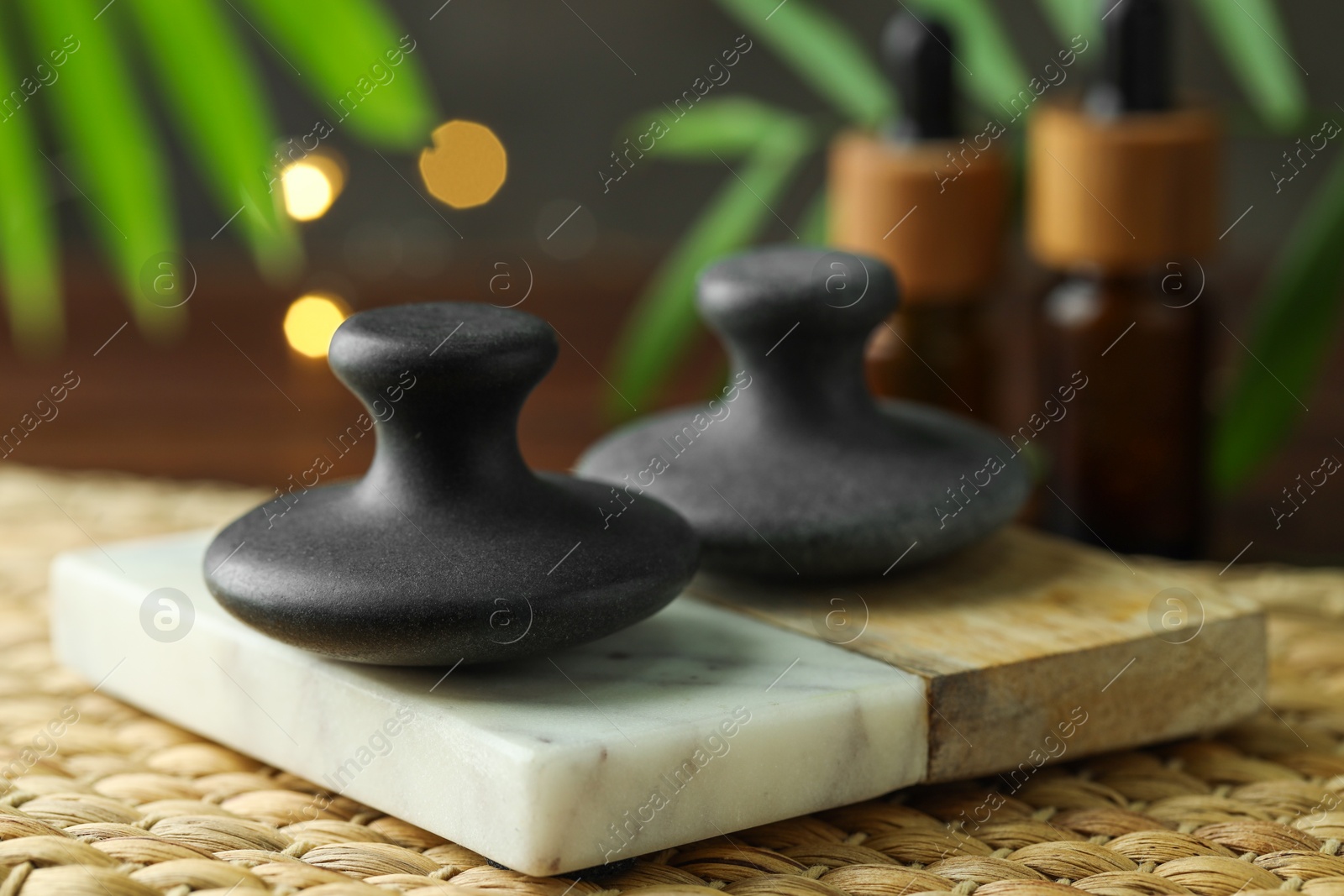 Photo of Spa stones, cosmetic products on table, closeup