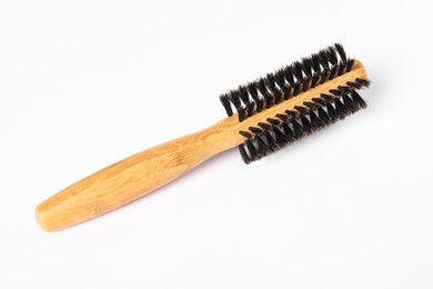 Photo of Hairdresser tool. Round wooden brush on white background, top view