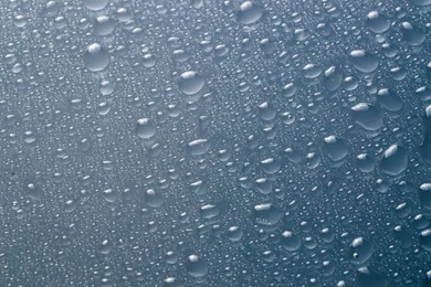 Water drops on light glass surface, top view