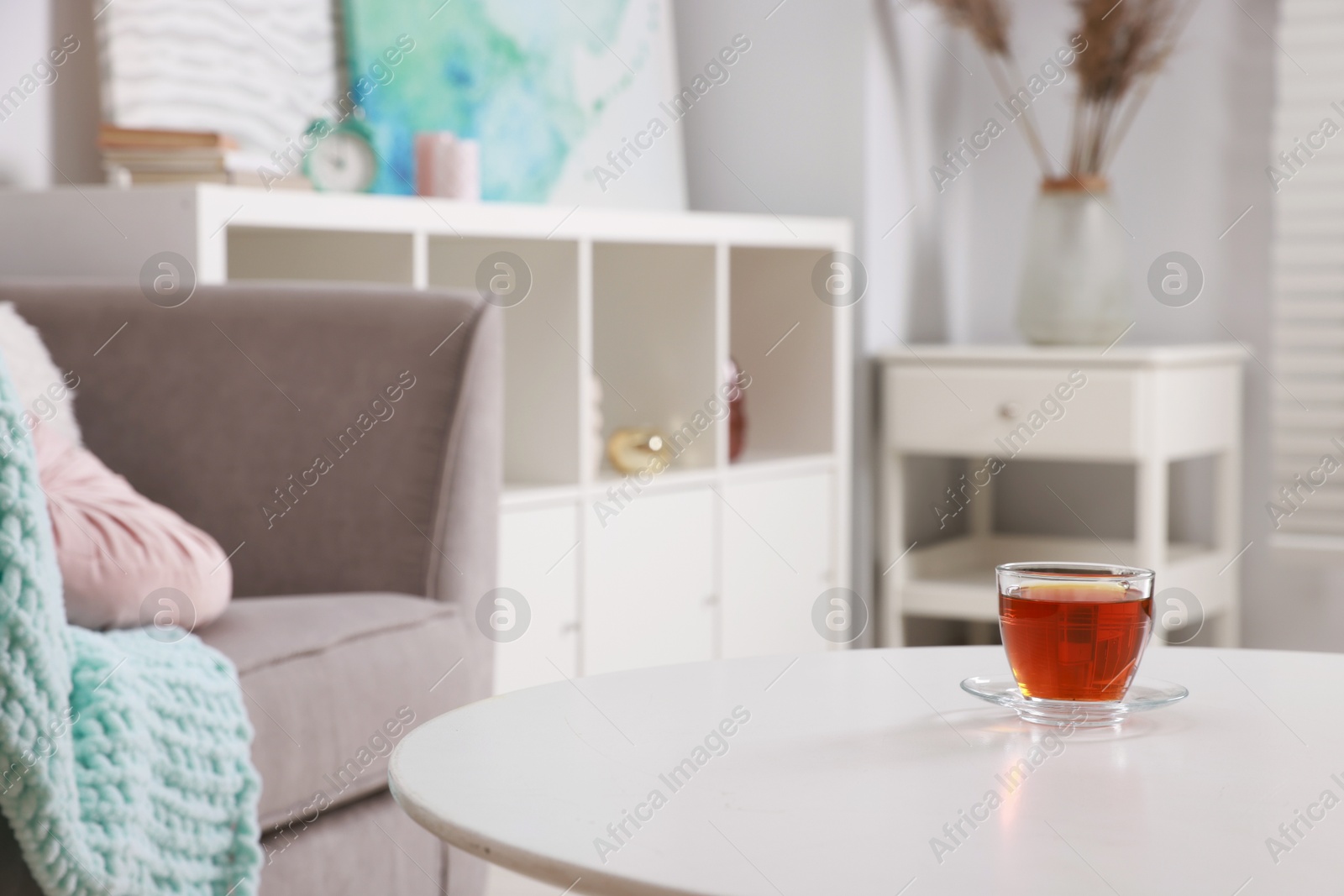 Photo of Stylish coffee table with tea at home, closeup