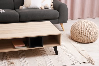 Photo of Stylish coffee table near sofa at home