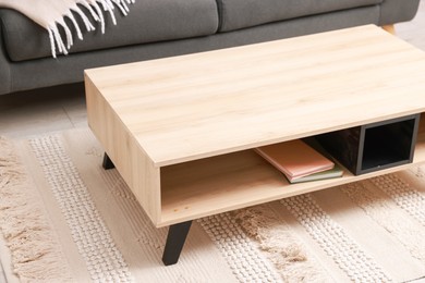 Photo of Stylish coffee table near sofa at home