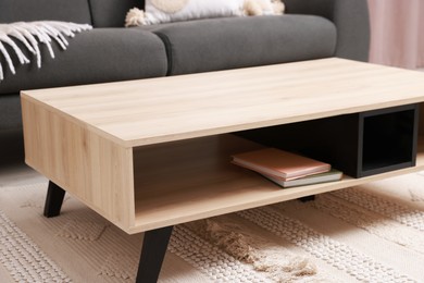 Photo of Stylish coffee table near sofa at home