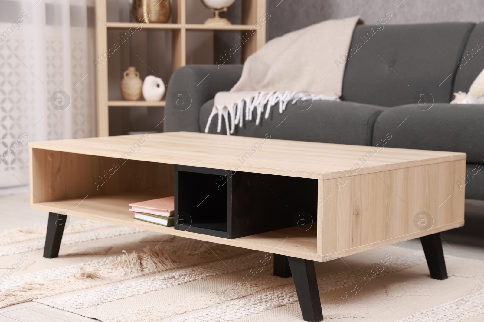 Photo of Stylish coffee table near sofa at home