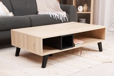 Photo of Stylish coffee table near sofa at home