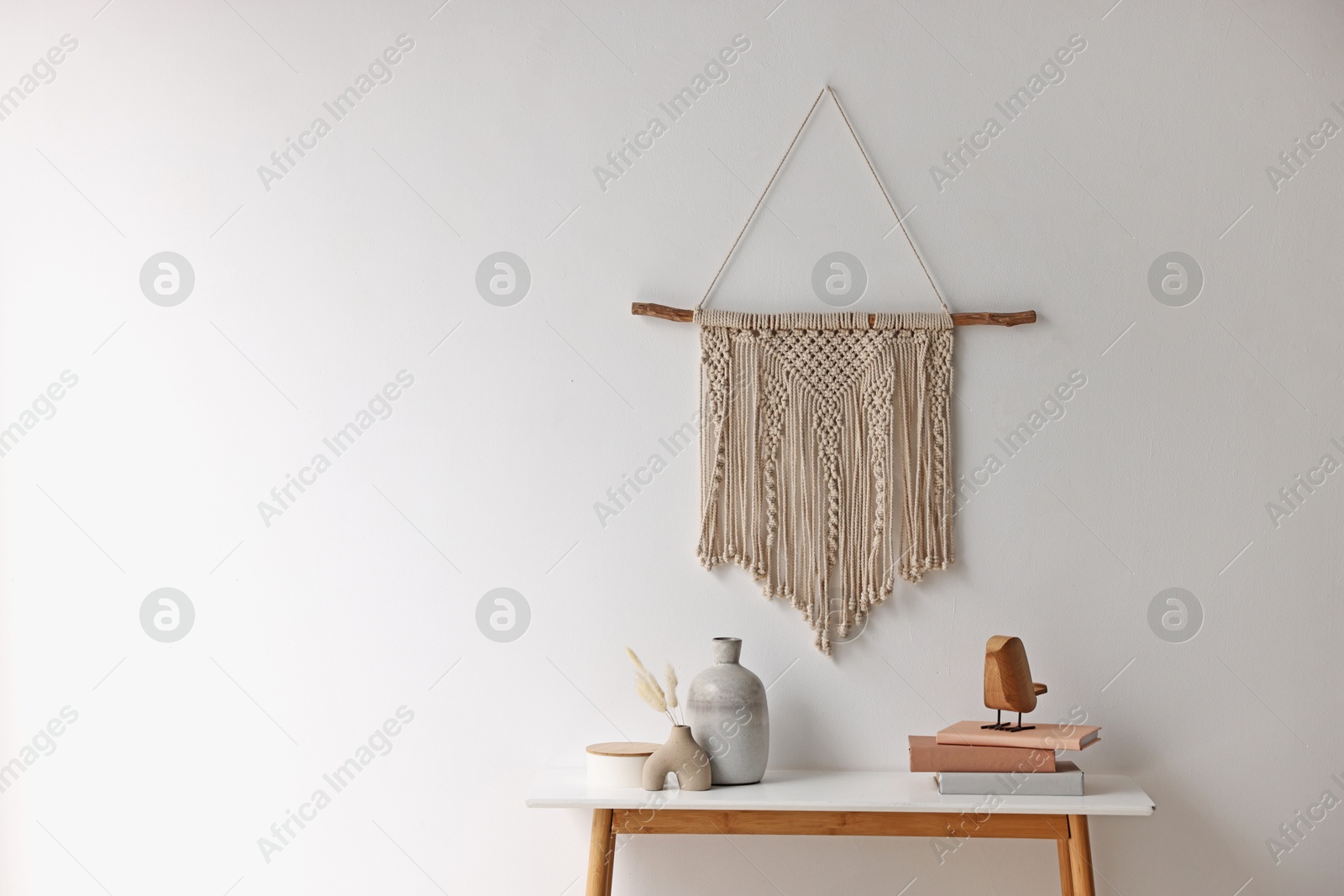 Photo of Stylish console table with decor near white wall indoors. Space for text