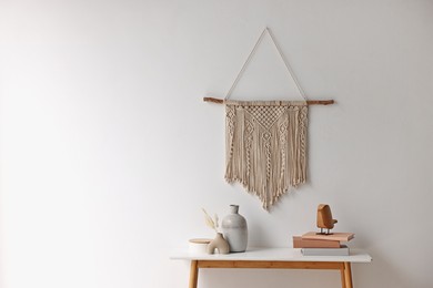 Photo of Stylish console table with decor near white wall indoors. Space for text