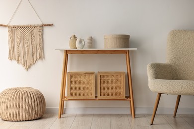 Photo of Stylish room interior with console table near white wall