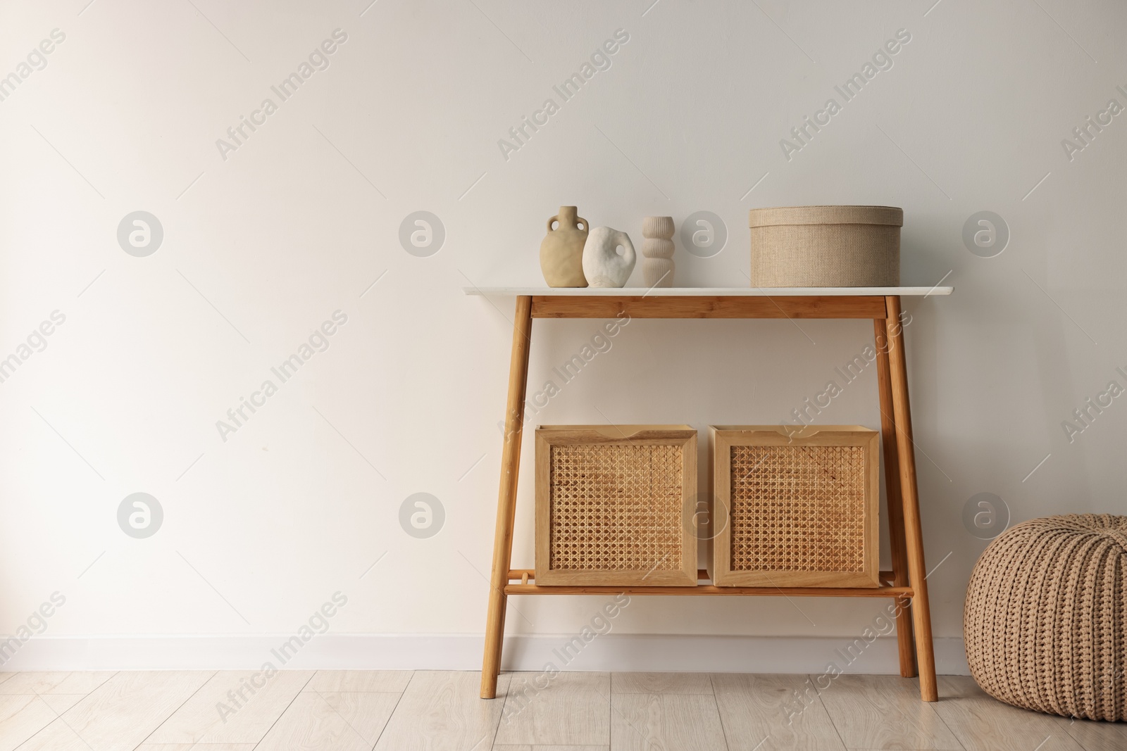 Photo of Stylish console table with decor near white wall indoors. Space for text