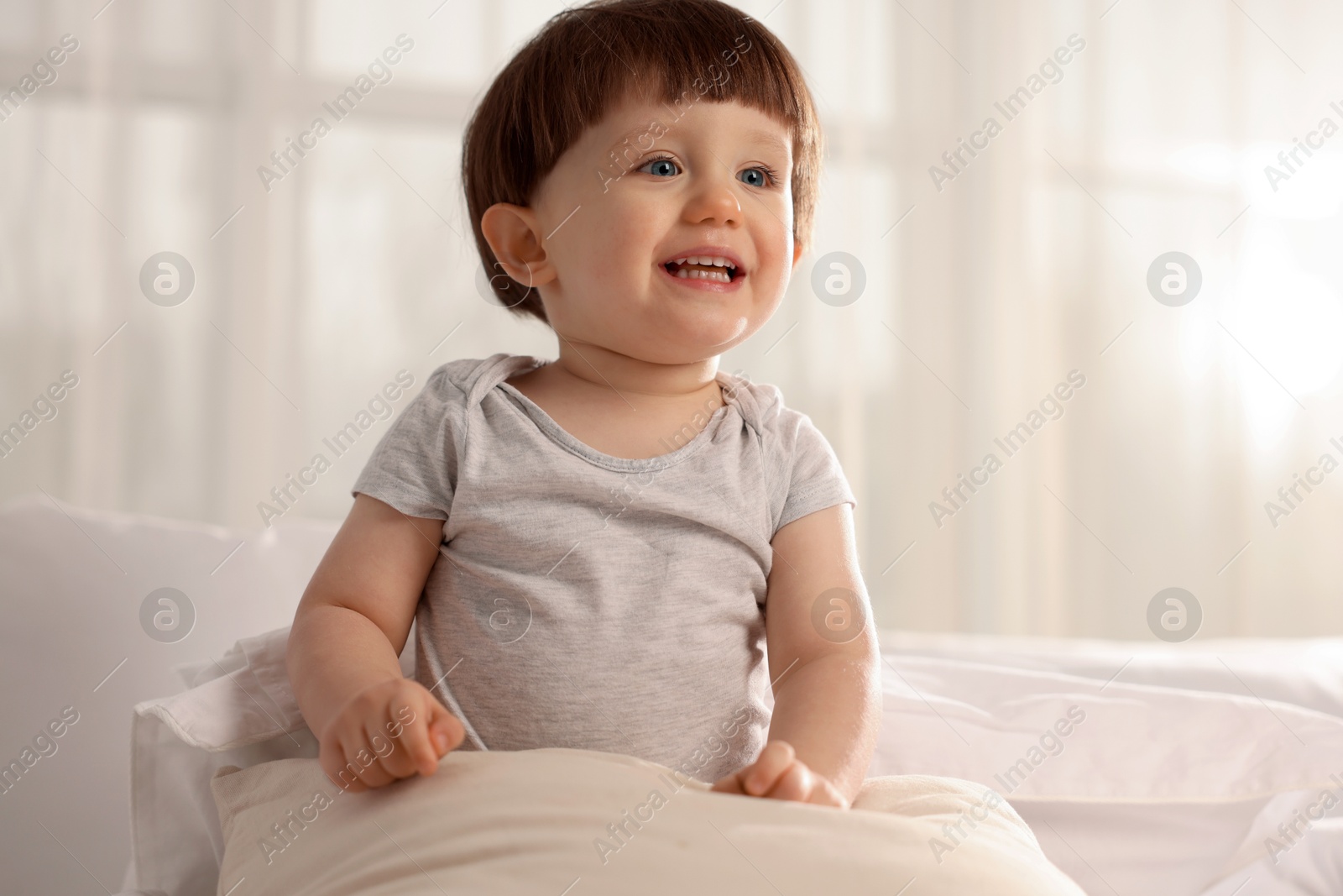 Photo of Cute little boy in bed at home, space for text