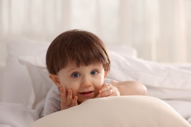 Photo of Cute little boy in bed at home