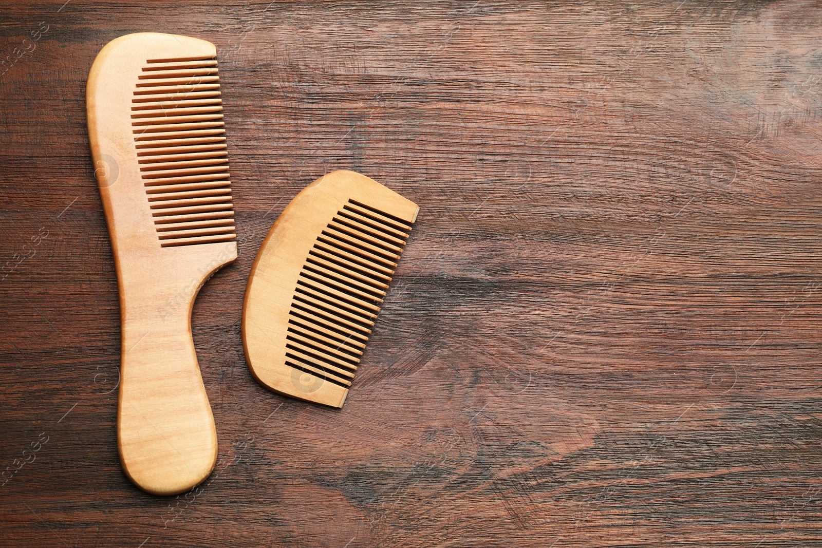 Photo of Different hair combs on wooden background, top view. Space for text