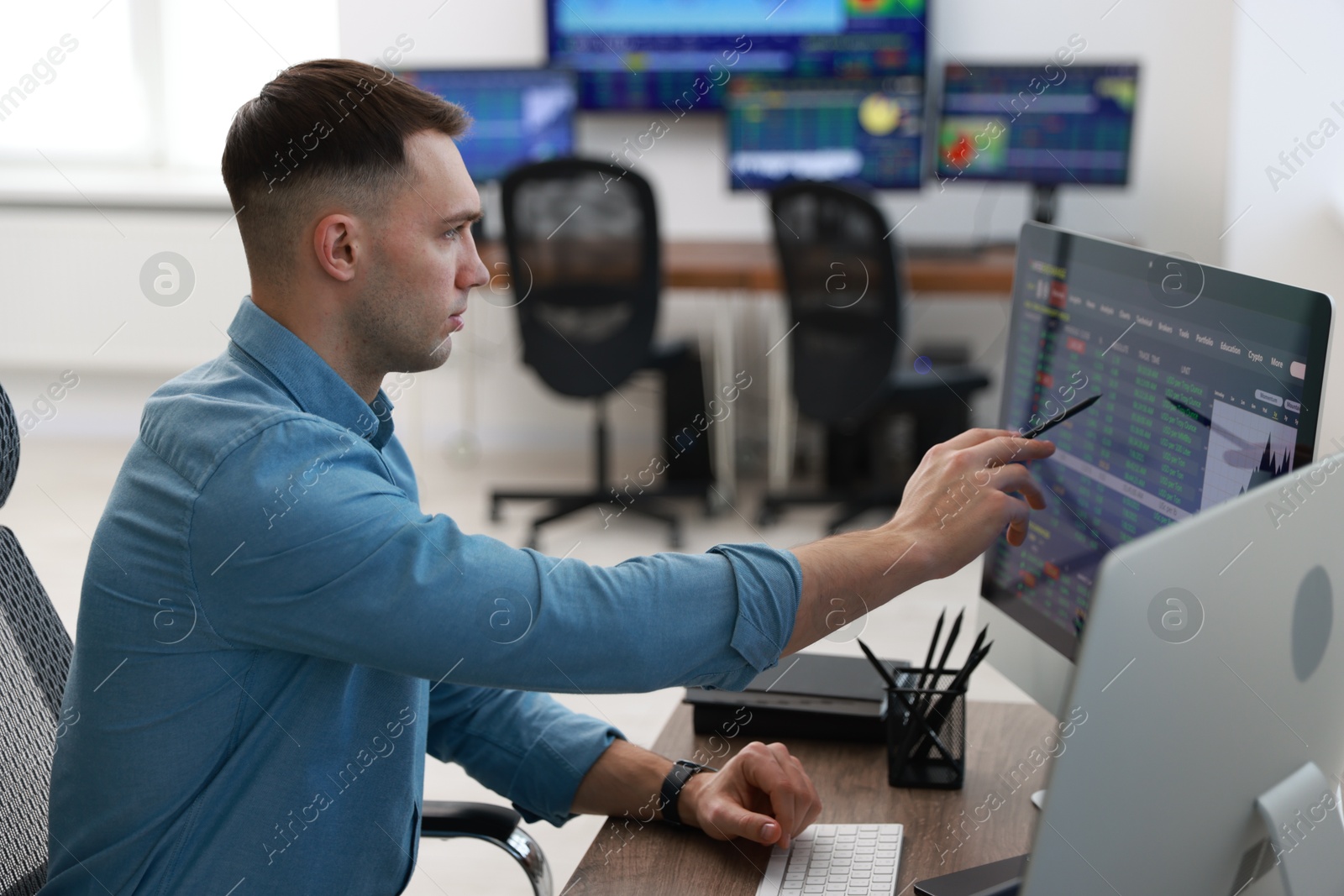 Photo of Financial trading specialist working with data in office