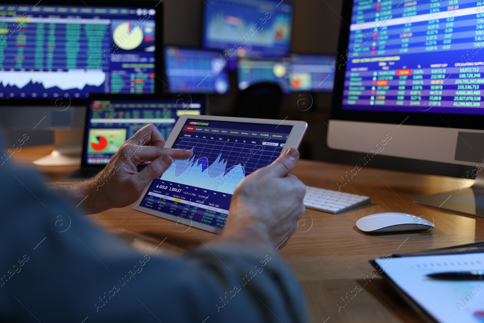 Photo of Financial trading specialist with tablet in office at night, closeup