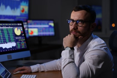 Photo of Portrait of financial trading specialist in office at night