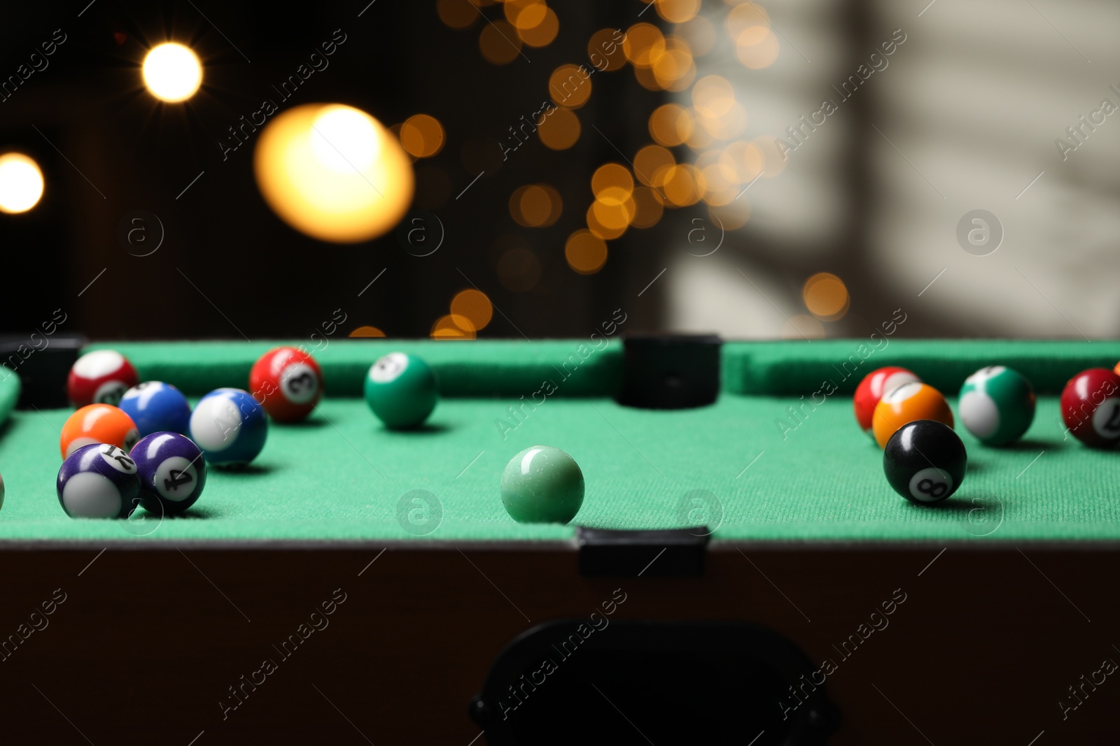 Photo of Many colorful billiard balls on green table indoors, closeup. Space for text