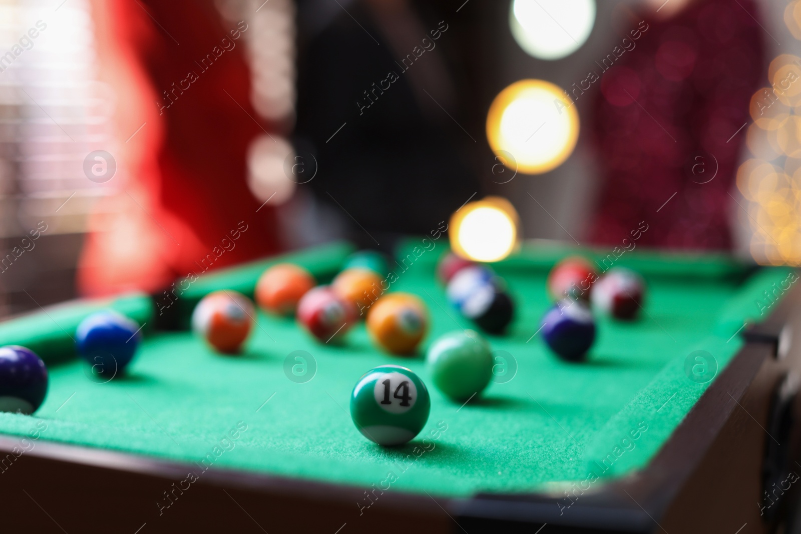 Photo of Many colorful billiard balls on green table indoors, closeup. Space for text