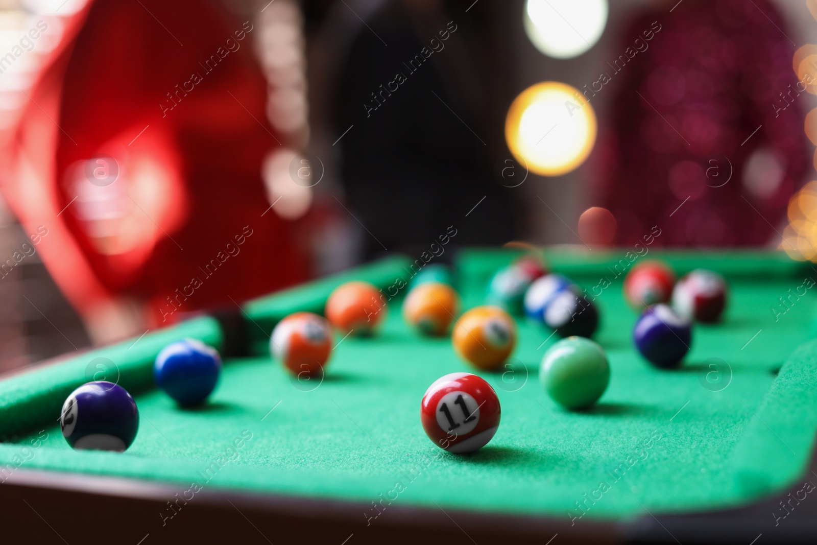 Photo of Many colorful billiard balls on green table indoors, closeup. Space for text