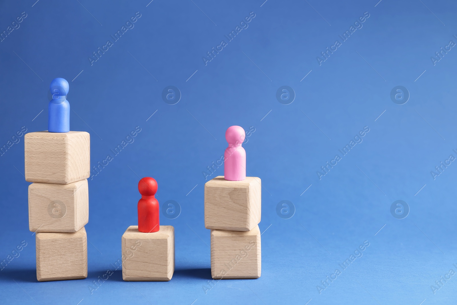 Photo of Competition concept. Human figures on wooden cubes against blue background, space for text