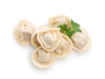 Photo of Delicious boiled dumplings (pelmeni) with fresh parsley isolated on white, top view