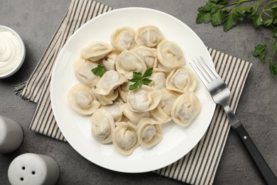 Photo of Delicious dumplings served on grey table, flat lay