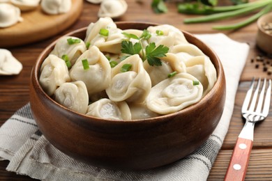 Photo of Delicious dumplings served on wooden table, closeup