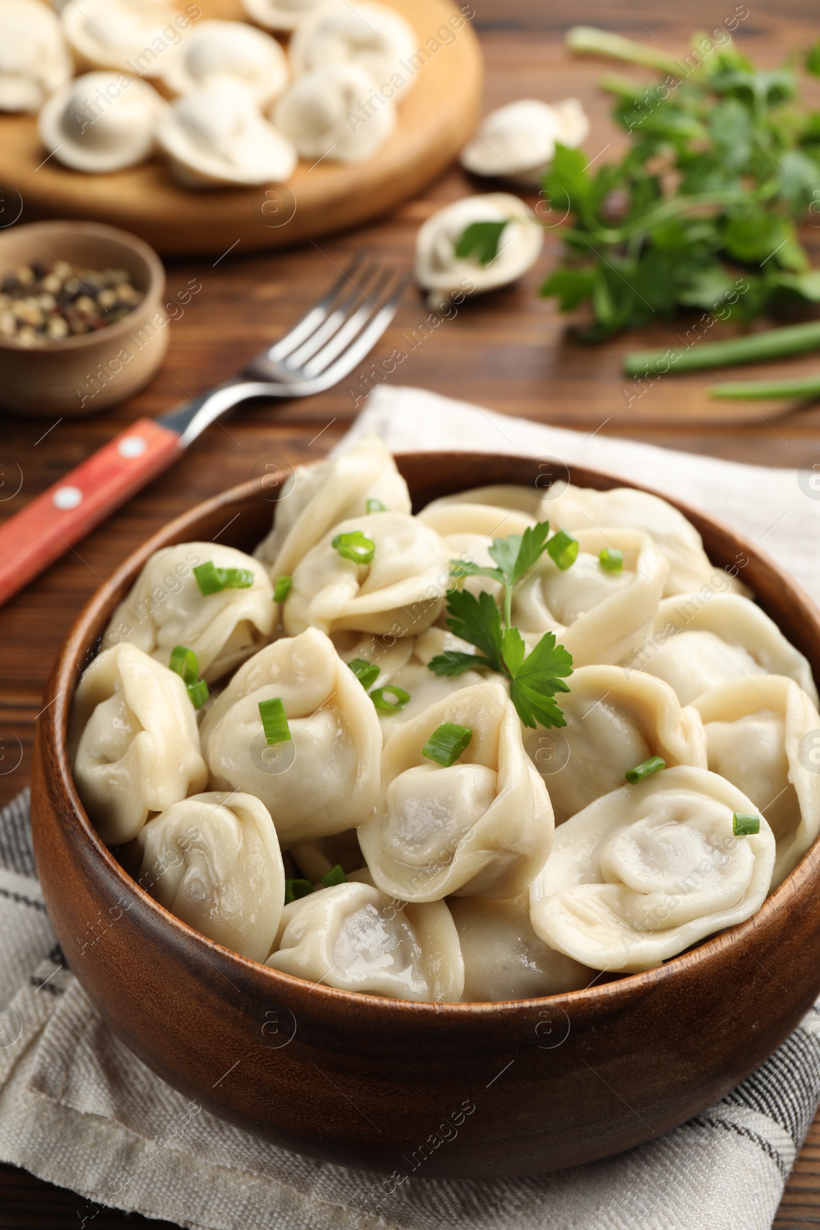 Photo of Delicious dumplings served on wooden table, closeup